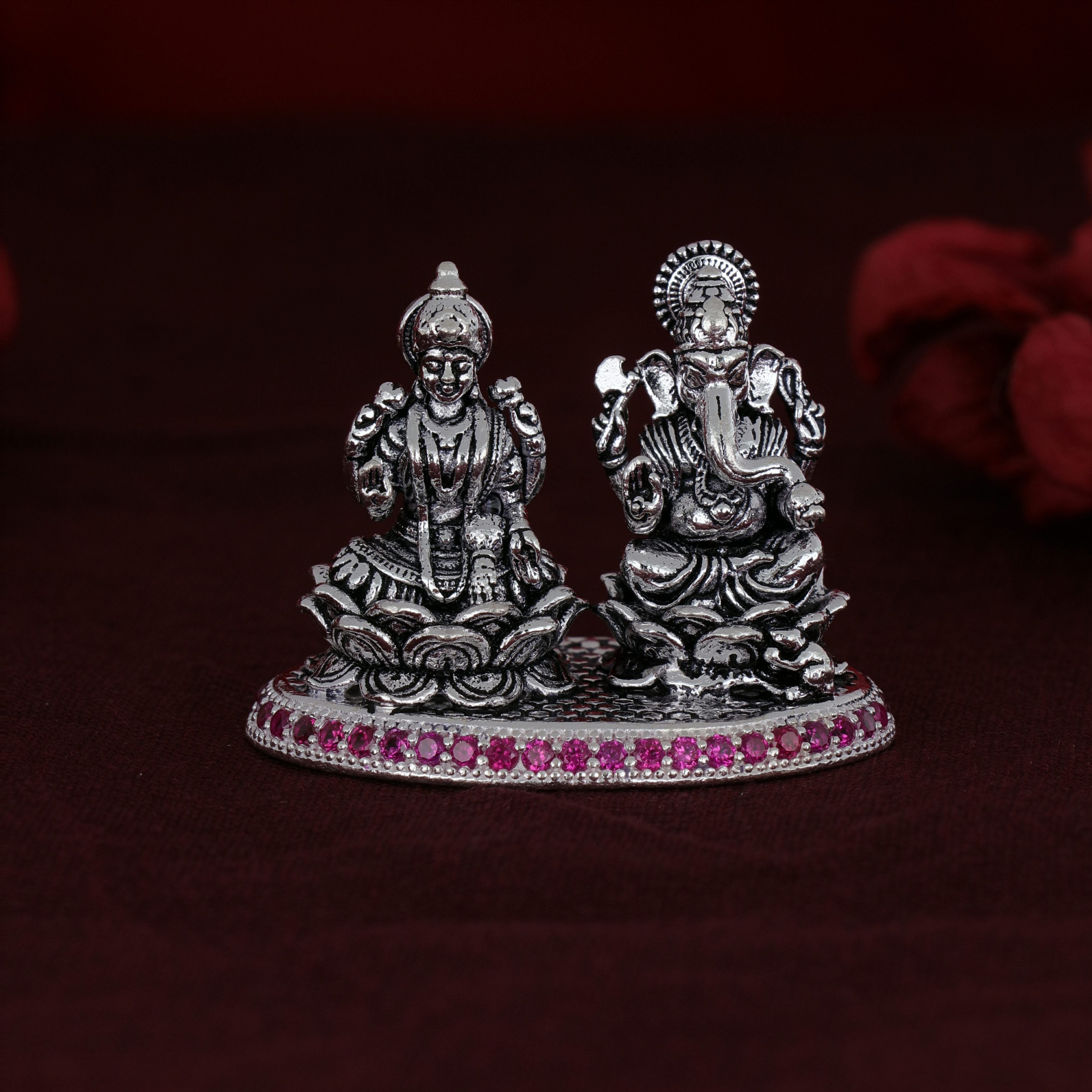 Shri Ganesh Laxmiji Micro Silver Murti Collection adorned with exquisite pink stones.