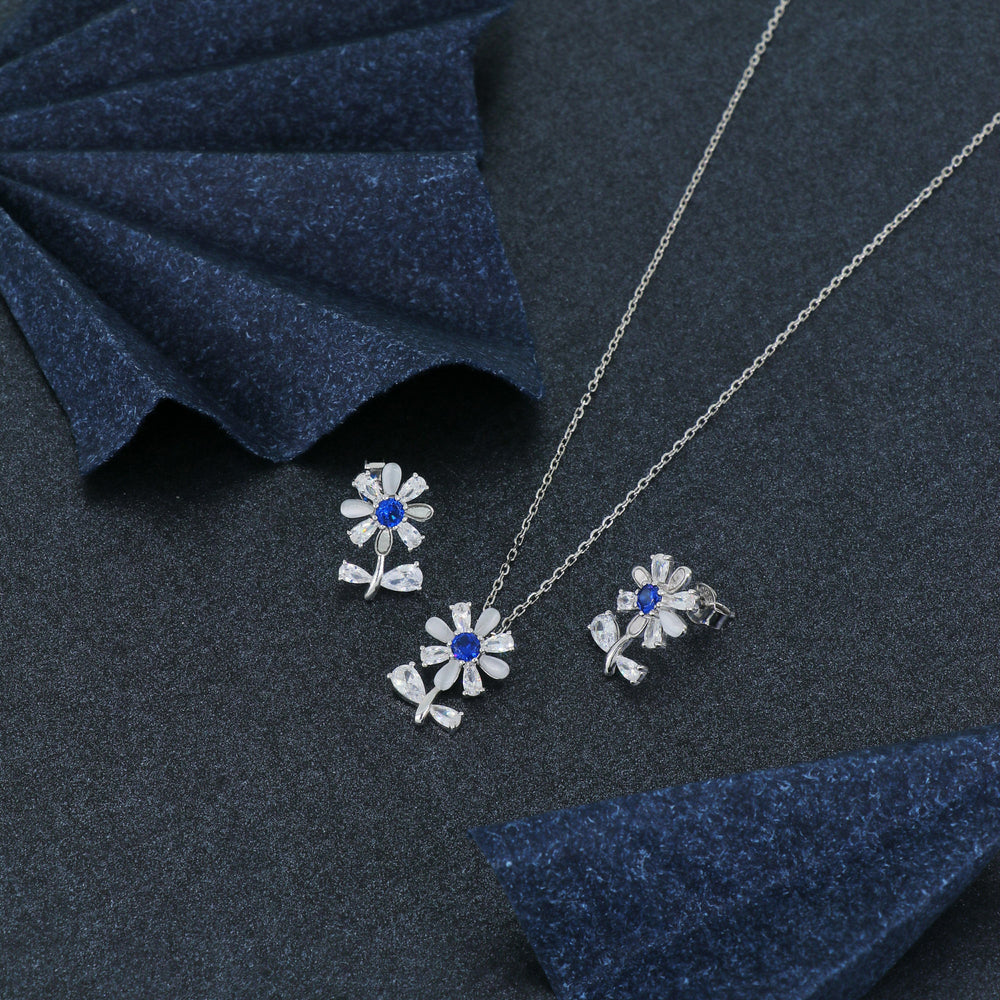 925 sterling silver floral pendant set with matching earrings featuring blue gemstones