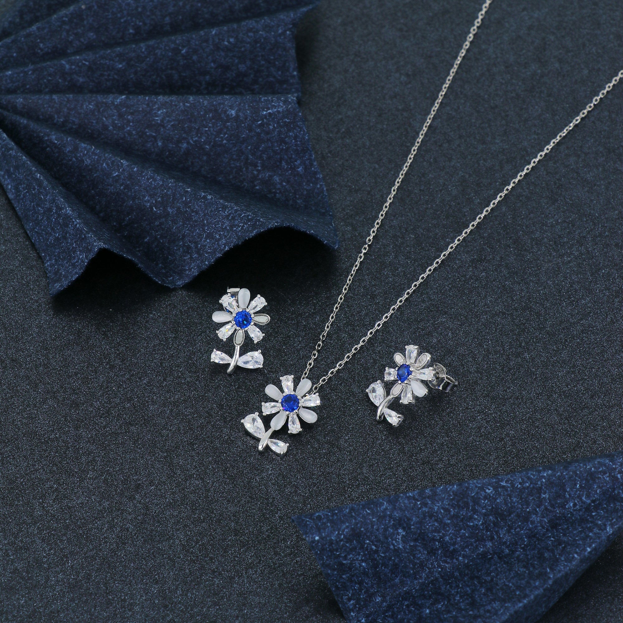 925 sterling silver floral pendant set with matching earrings featuring blue gemstones